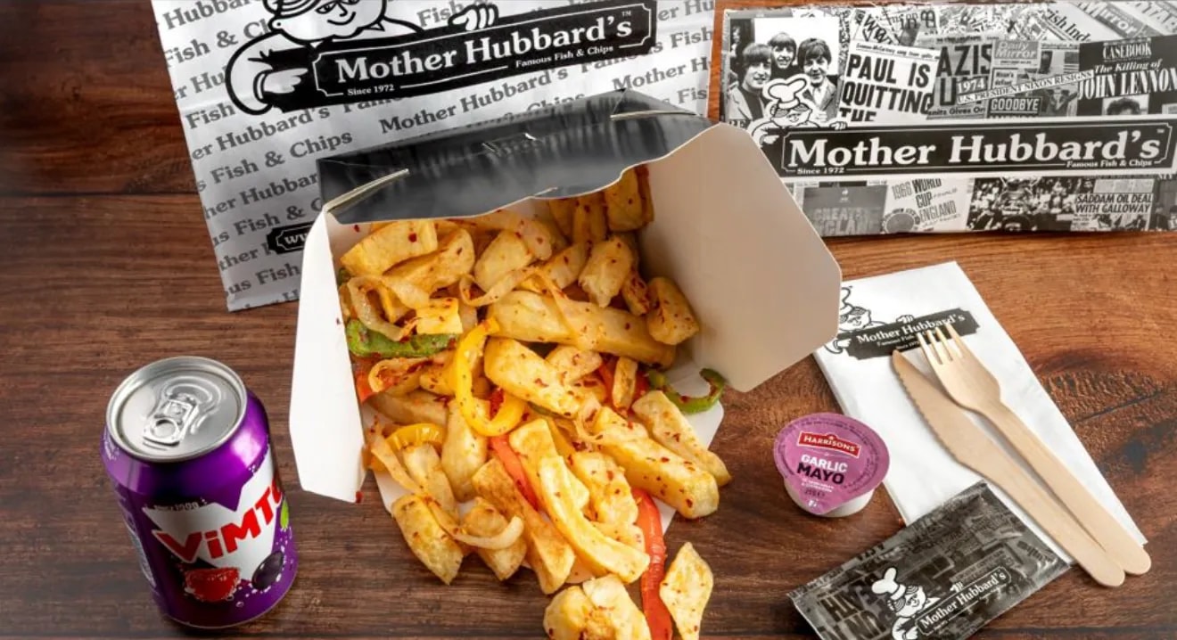 Salt and pepper chips with peppers in an open box, beside a can of Vimto