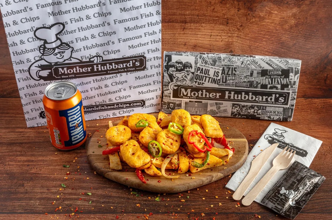 Salt and pepper nuggets with peppers, onions and chillies on a board, with a can of Irn-Bru